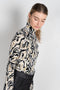 The turtleneck top by Paco Rabanne is a structured jacquard top in a black, gold and cream print