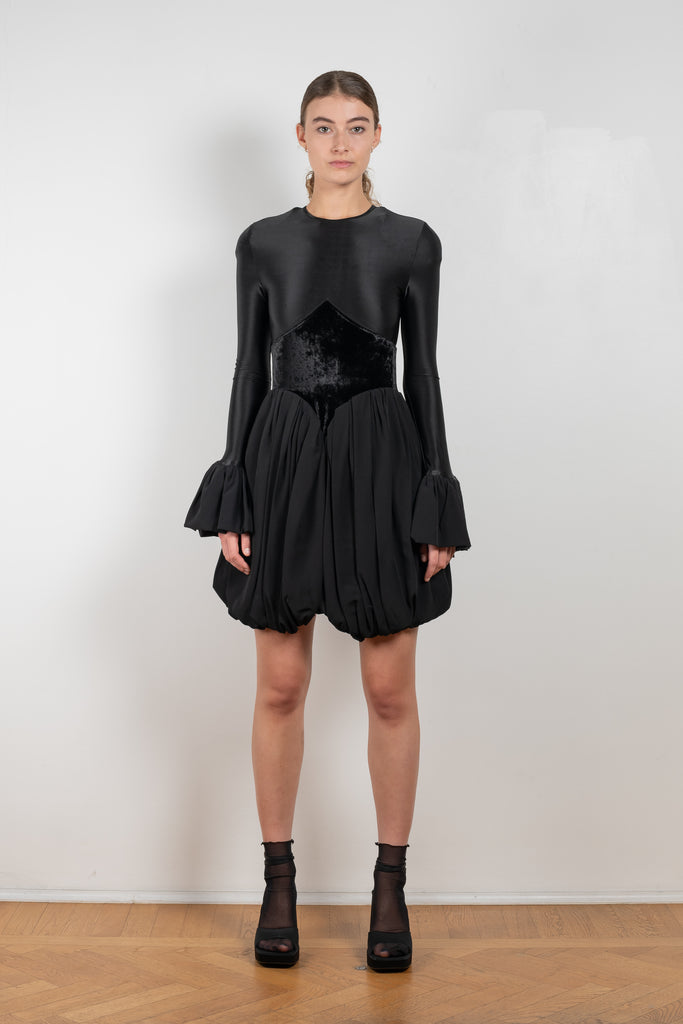 The Velvet Panel Mini Dress by Paco Rabanne is a short dress with a velvet panel, a puffed skirt and long flared sleeves