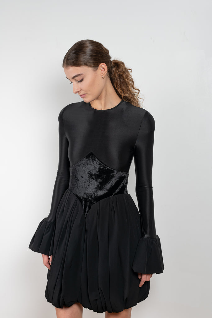 The Velvet Panel Mini Dress by Paco Rabanne is a short dress with a velvet panel, a puffed skirt and long flared sleeves