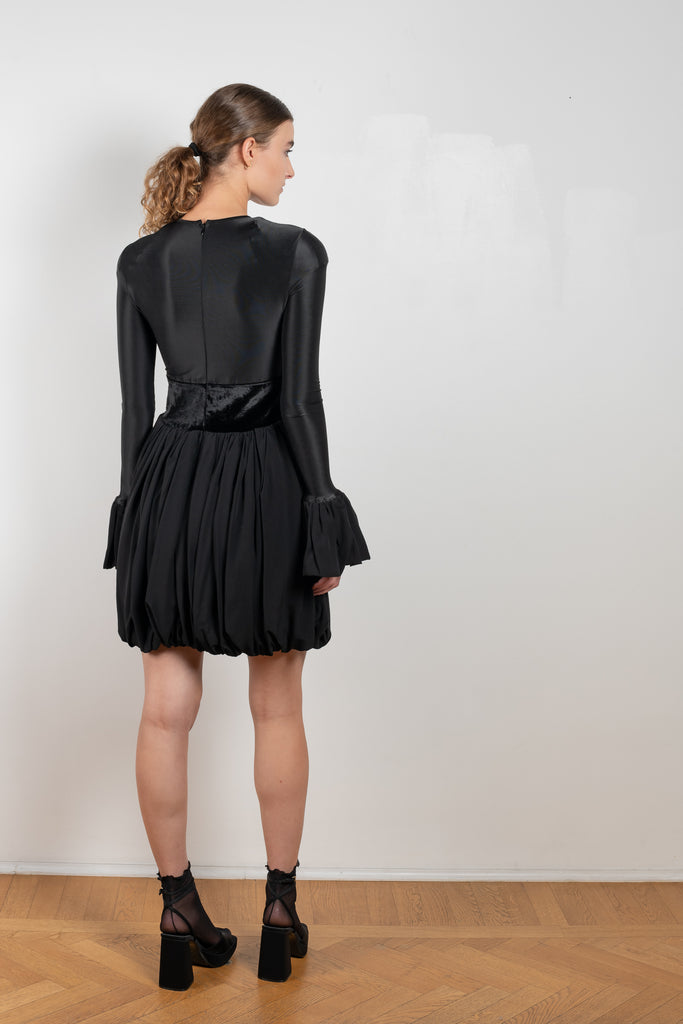 The Velvet Panel Mini Dress by Paco Rabanne is a short dress with a velvet panel, a puffed skirt and long flared sleeves