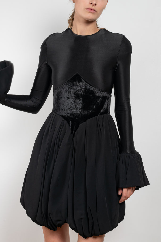 The Velvet Panel Mini Dress by Paco Rabanne is a short dress with a velvet panel, a puffed skirt and long flared sleeves