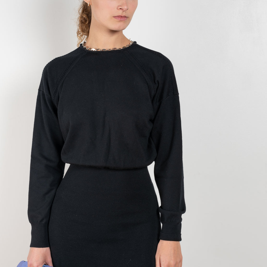 The Chain Wool Dress by Paco Rabanne is a fine merino wool dress with a link chain collar, a loose upper part and a fitted skirt