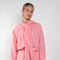 The Jolene Top by Rejina Pyo is a loose top with long sleeves and a fabric overlay scarf detail in a pink fluid viscose