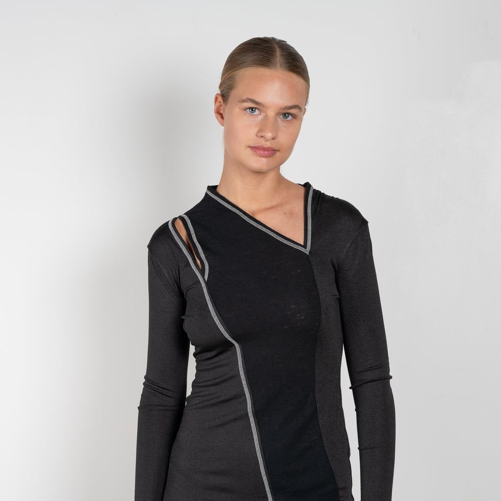 The Mavis Dress by Rejina Pyo is close to the body dress with a shoulder cut-out and contrast stitch detailing