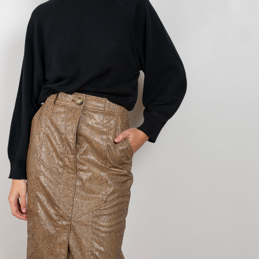 The Riley Skirt by Rejina Pyo is a high waisted pencil skirt with a front slit in a snakeskin faux leather