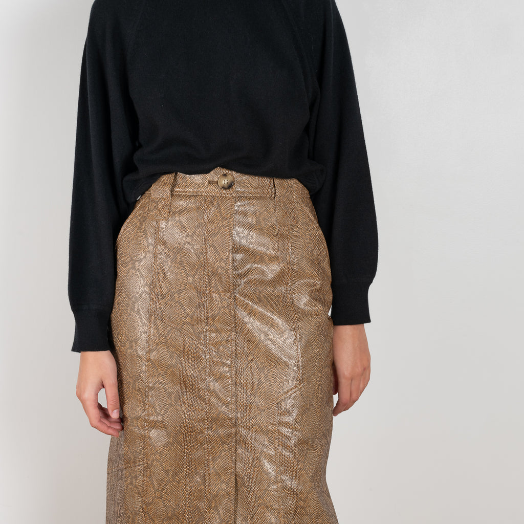 The Riley Skirt by Rejina Pyo is a high waisted pencil skirt with a front slit in a snakeskin faux leather