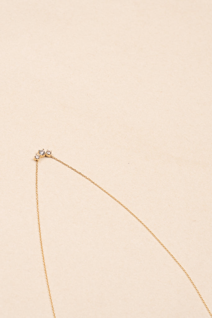 The Orangerie Trois Necklace by Sophie Bille Brahe has three petite diamonds that sit loose on the delicate gold chain allowing them to move elegantly as the necklace is worn