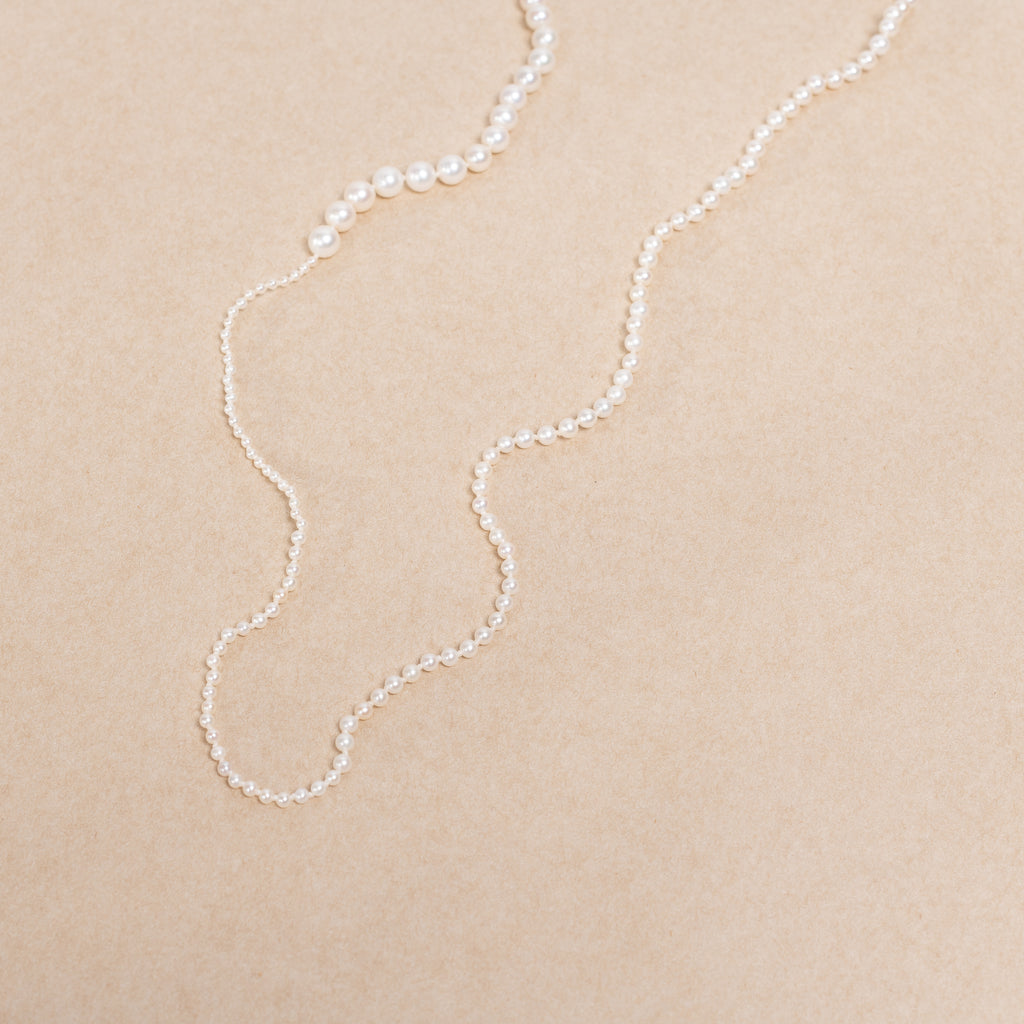 The Petite Peggy Perle Necklace is a longer version of the classic Petite Peggy Necklace with graduating sized Freshwater Pearls on an ancient Gold Lock