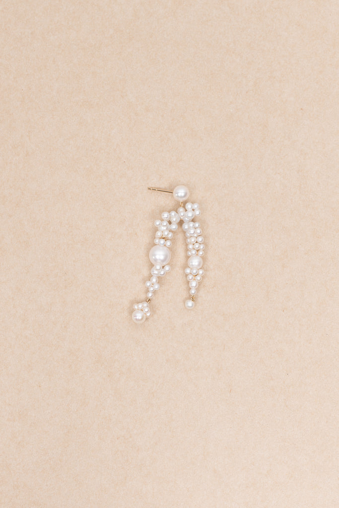 The Fontaine Nuit Earring by Sophie Bille Brahe is a statement drop earring with white freshwater pearls varying in size