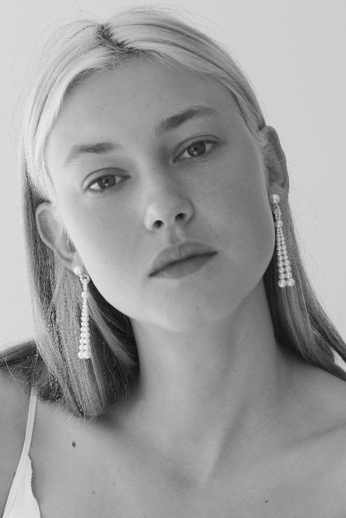 The Opera Earrings by Sophie Bille Brahe are statement drop earrings with white freshwater pearls graduating in size